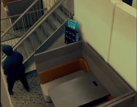 Overhead camera view of a hooded figure by a stairwell